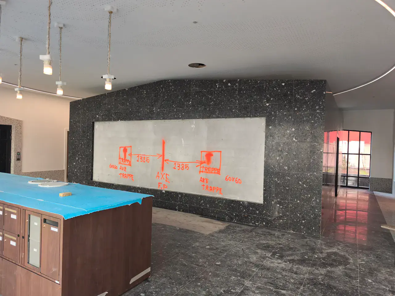 Repérages techniques tracés dans un hall de résidence en rénovation